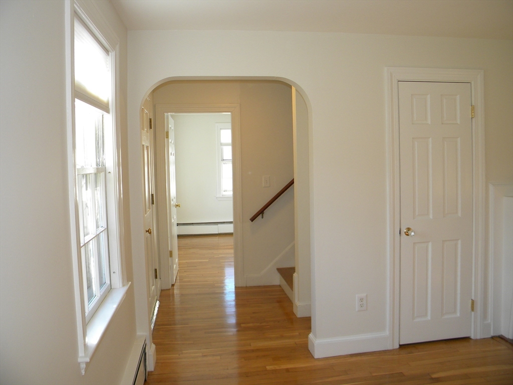 21 Lovers Lane Groton, MA 01450 - Photo 10 of 35 a view of a hallway with wooden floor and staircase