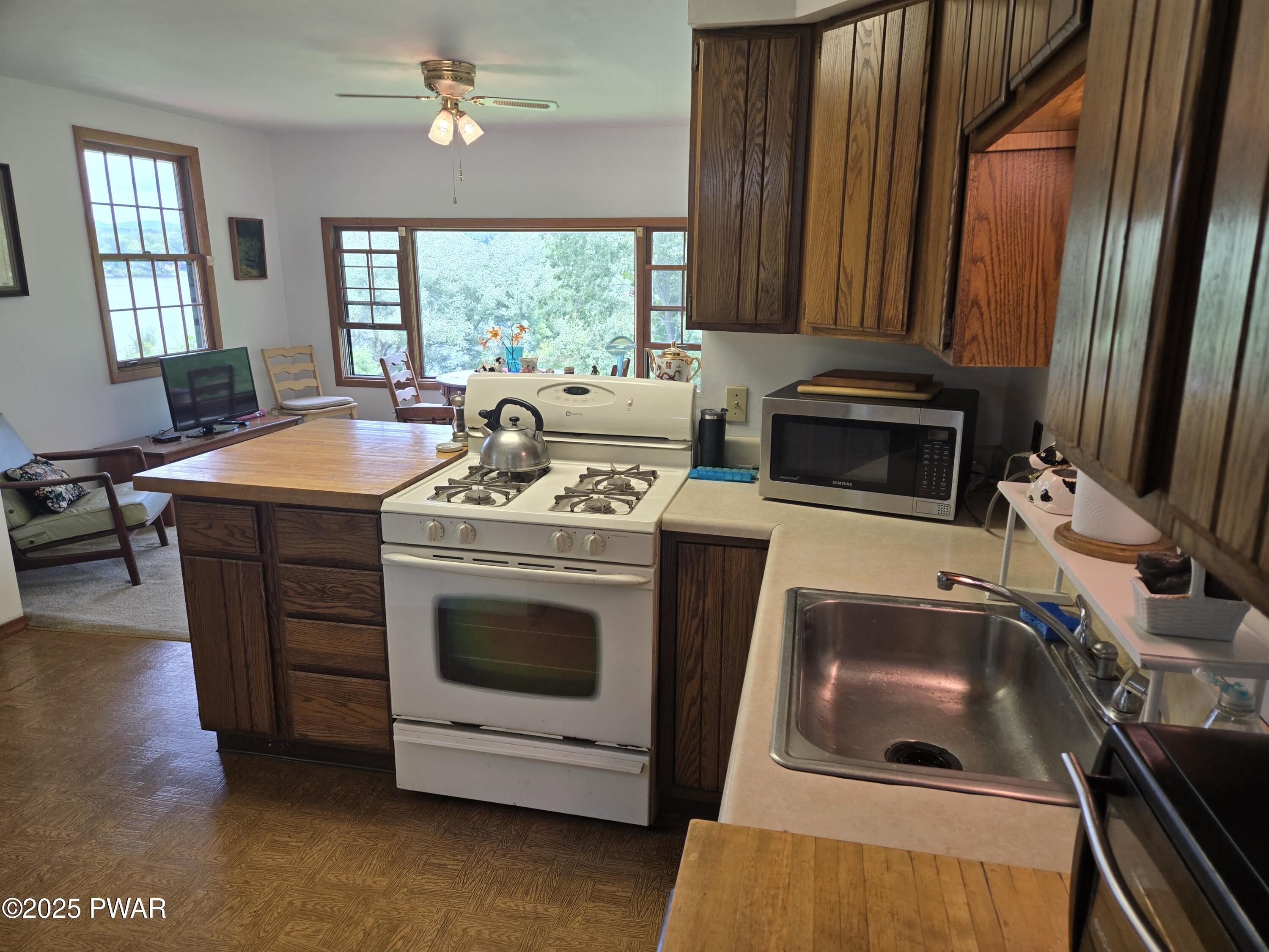 1467 Cortez Road Lake Ariel, PA 18436 - Photo 11 of 36 a kitchen with a stove and a microwave