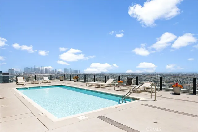 a outdoor patio with swimming pool and furniture