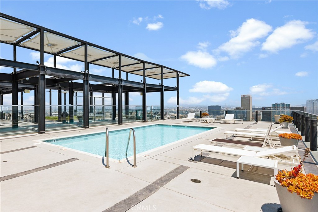 3810 Wilshire Boulevard, Unit 2002 Los Angeles, CA 90010 - Photo 15 of 25 a view of a swimming pool with a lounge chairs