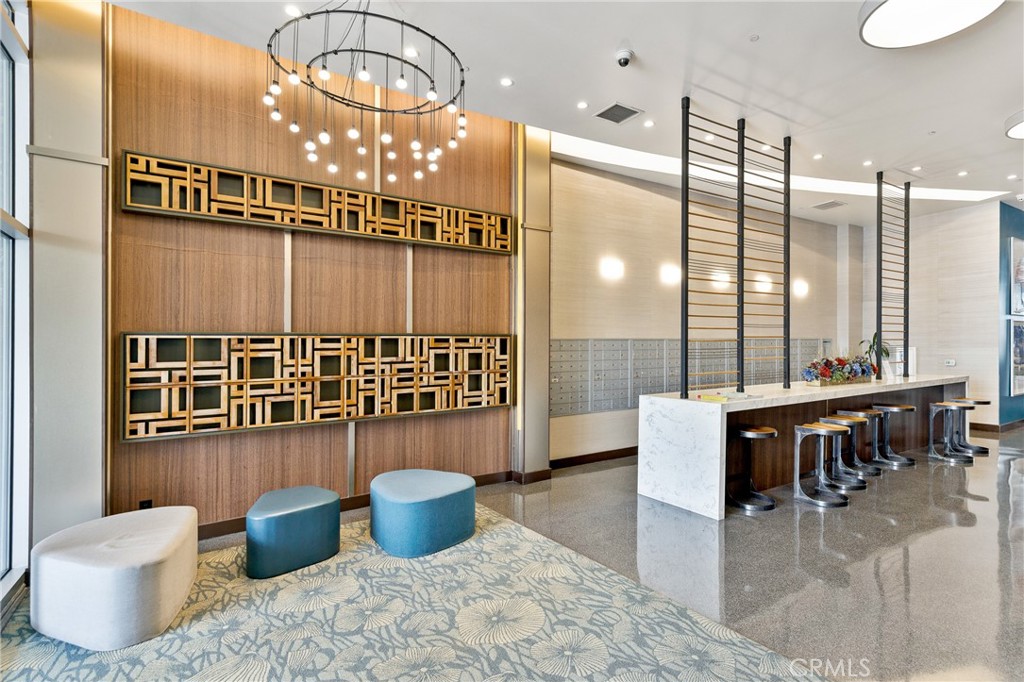3810 Wilshire Boulevard, Unit 2002 Los Angeles, CA 90010 - Photo 19 of 25 a living room with furniture a rug and a chandelier