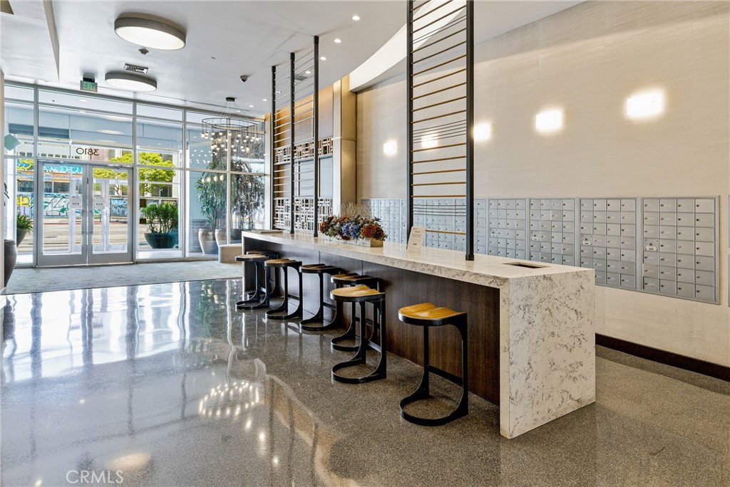 3810 Wilshire Boulevard, Unit 2002 Los Angeles, CA 90010 - Photo 20 of 25 a living room with furniture a window and appliances