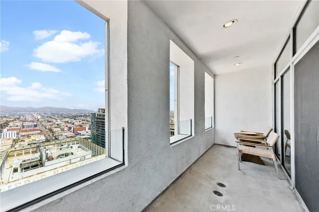 a view of a hallway with workspace and a window