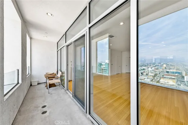 a view of a balcony with furniture and floor to ceiling window