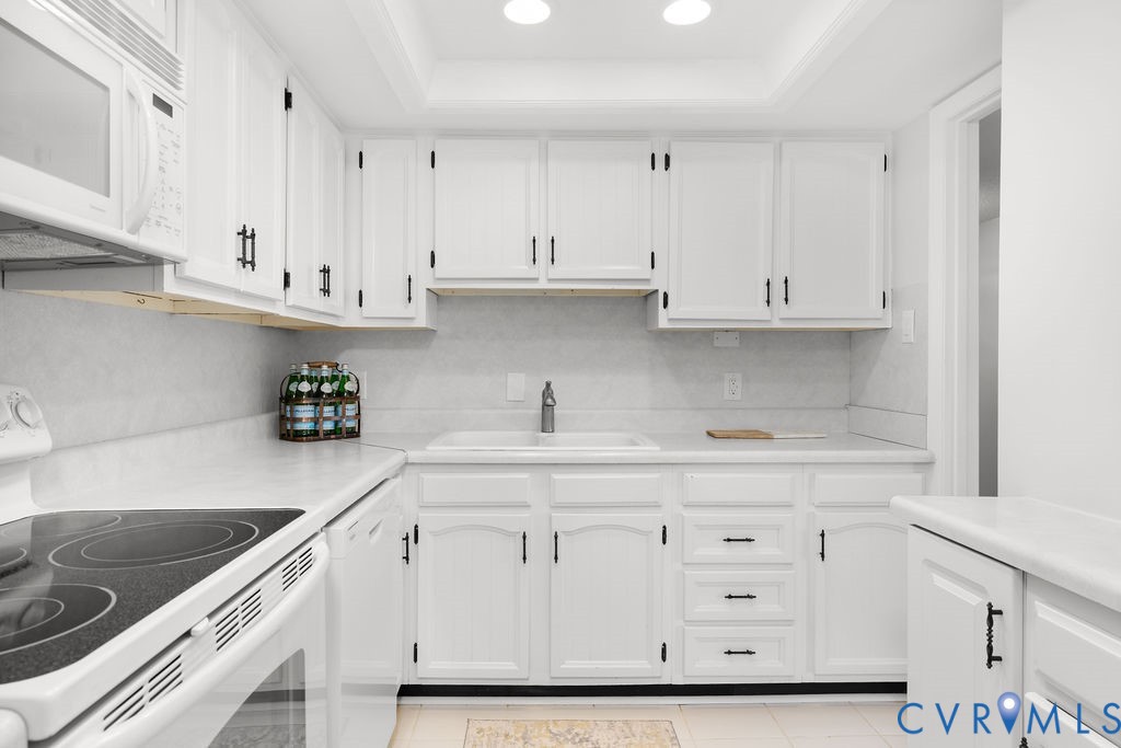 2956 Hathaway Road, Unit U704 Richmond, VA 23225 - Photo 6 of 42 Kitchen featuring white cabinetry with dark hardwa