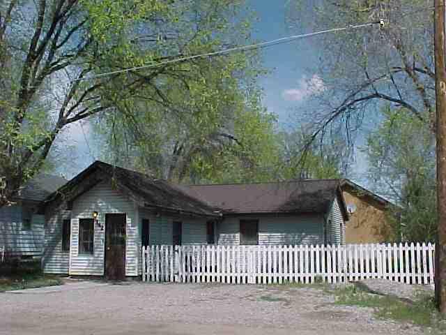 142 East 10th Street Rifle, CO 81650 - Photo 1 of 5 a view of a house with a small yard next to a house
