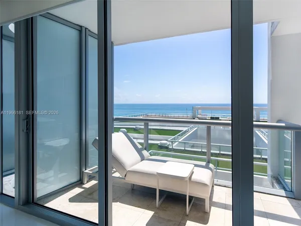 a view of a balcony with a table and chairs