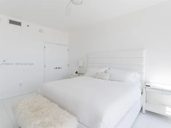 a large white bed in a white room