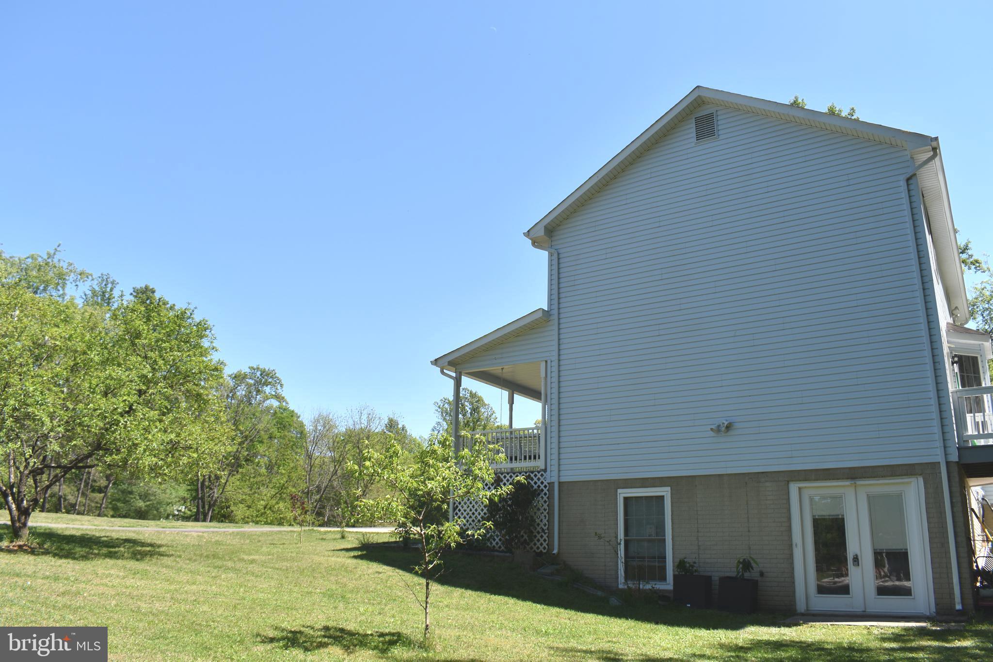 10958 Mountain Run Lake Road Culpeper, VA 22701 - Photo 28 of 31 a view of a house with backyard and trees