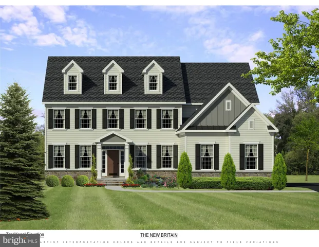 a front view of residential houses with yard and green space