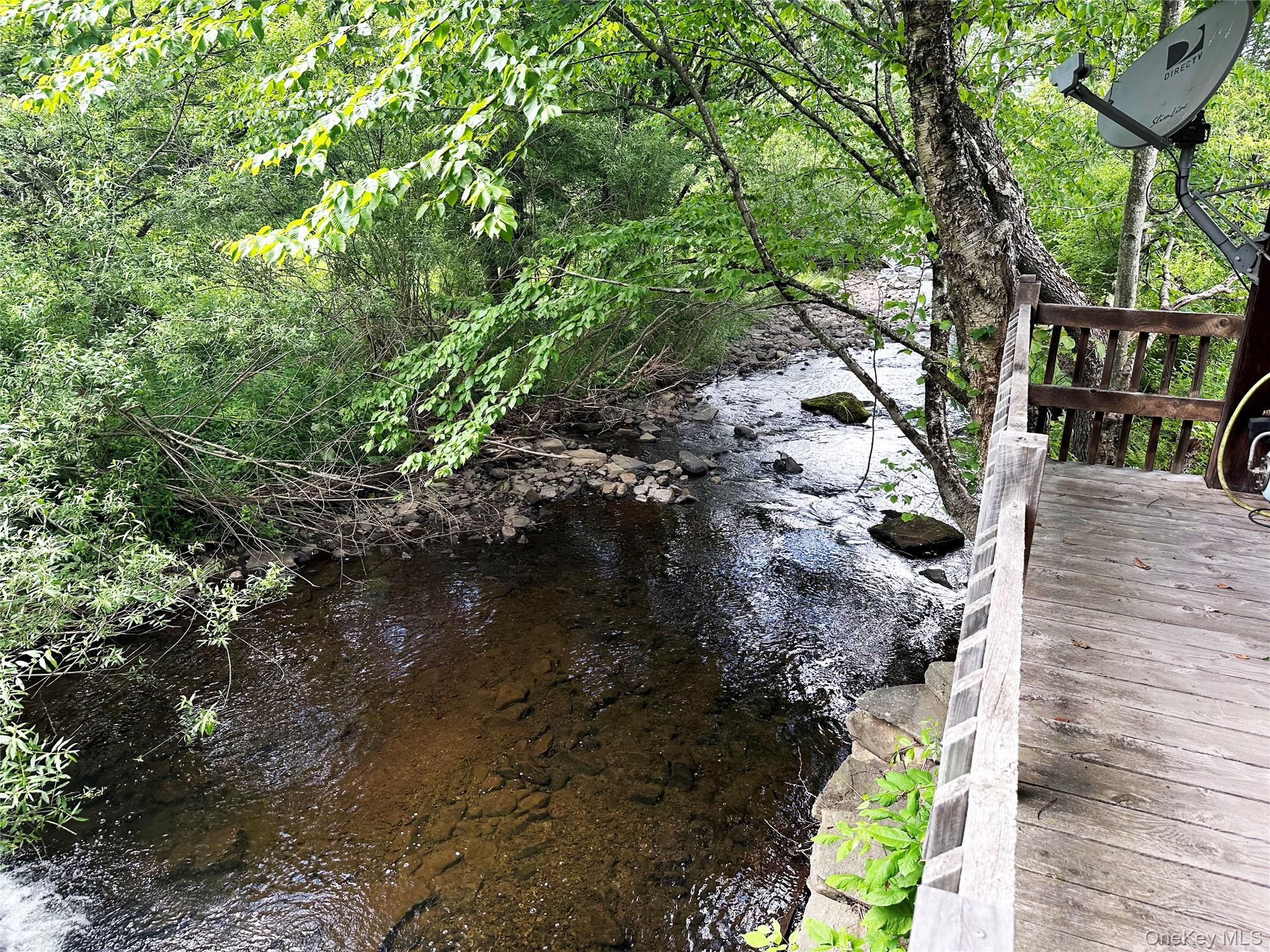 818 Methol Road Roscoe, NY 12776 - Photo 3 of 39 Covered porch overlooking Trout Brook, offering a rare opportunity to relax, entertain, or fish directly from the property.