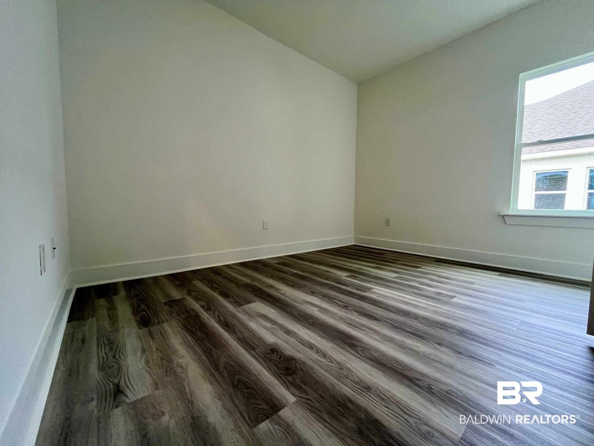334 Barndling Street Fairhope, AL 36532 - Photo 22 of 34 Empty room featuring dark hardwood / wood-style flooring and lofted ceiling