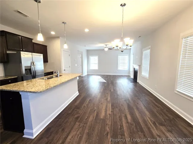 a view of a kitchen counter space wooden floor and staircase