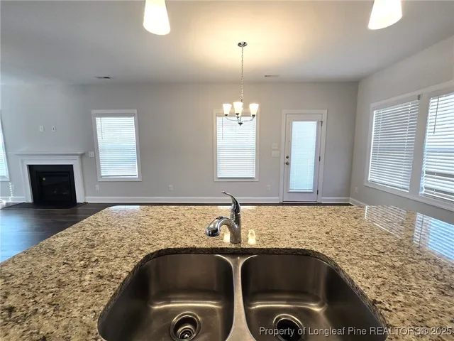 a kitchen with granite countertop a sink and a stove