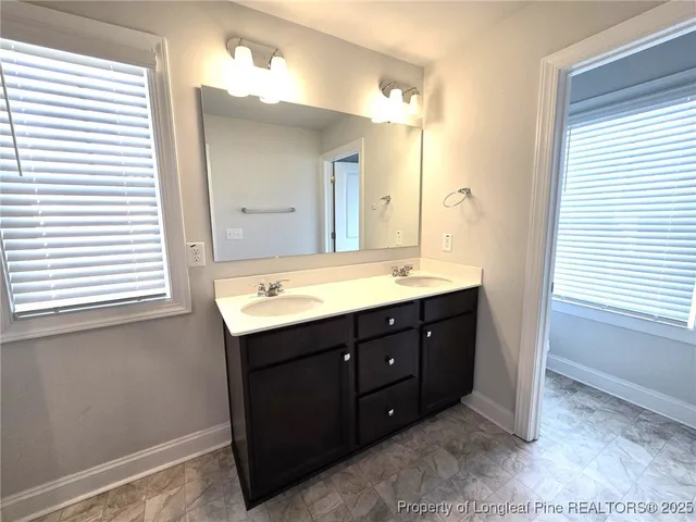 a bathroom with a sink a mirror and a shower
