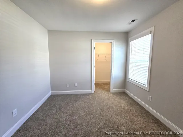 a bathroom with a double vanity sink a toilet a mirror and shower