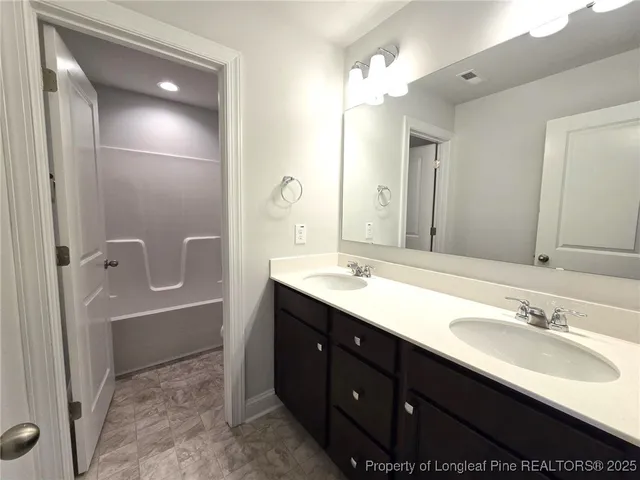 a white toilet sitting next to a bathroom sink and a shower