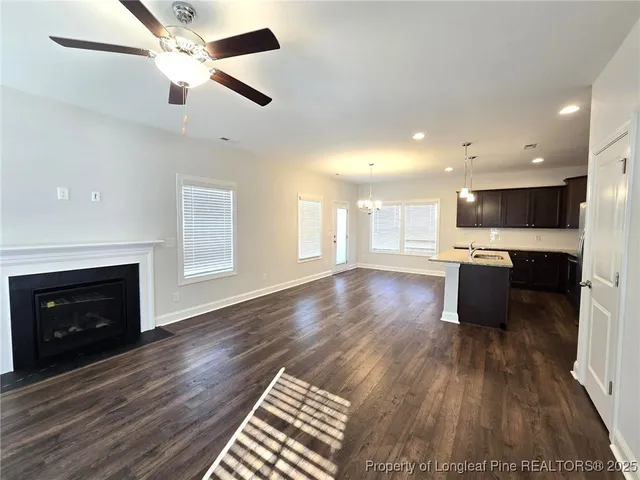 a open kitchen with a refrigerator and a stove top oven
