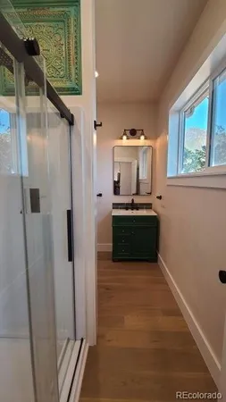 a bathroom with a sink vanity and mirror