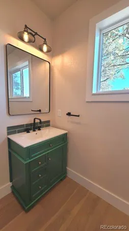a bathroom with a double vanity sink and a mirror