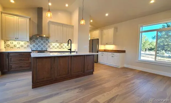 a bathroom with a granite countertop sink and a large mirror