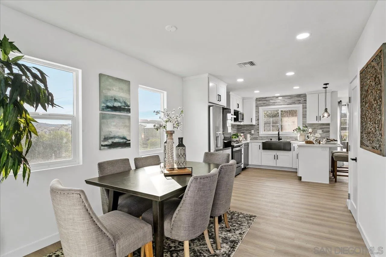 506 Brotherton Road Escondido, CA 92025 - Photo 11 of 31 a view of a dining room with furniture and wooden floor