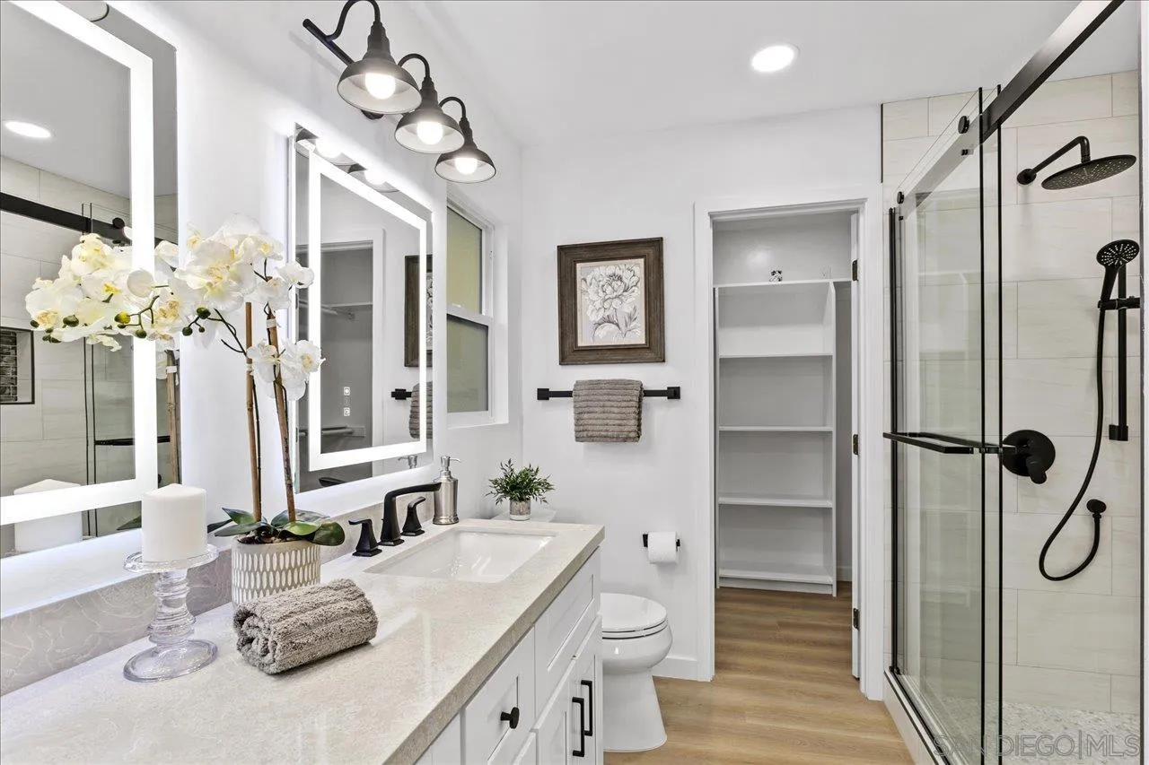 506 Brotherton Road Escondido, CA 92025 - Photo 17 of 31 a bathroom with a granite countertop sink a toilet and shower