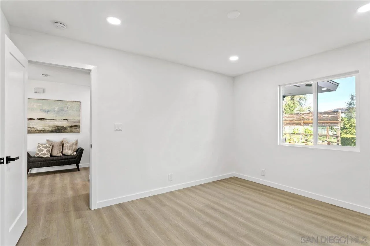 506 Brotherton Road Escondido, CA 92025 - Photo 19 of 31 a view of a hallway to a room with wooden floor and windows