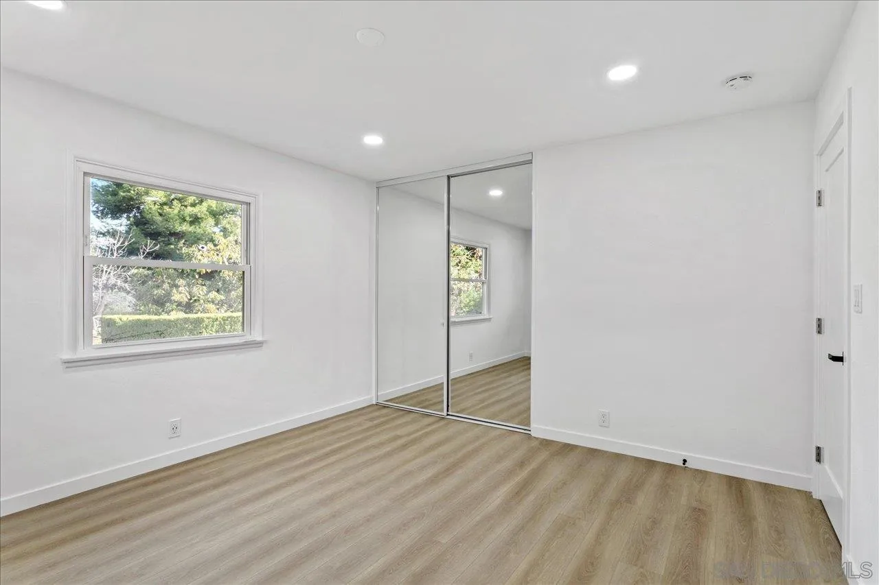 506 Brotherton Road Escondido, CA 92025 - Photo 22 of 31 an empty room with wooden floor and window