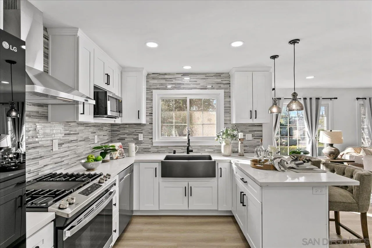 506 Brotherton Road Escondido, CA 92025 - Photo 8 of 31 a kitchen with stainless steel appliances a sink a stove a kitchen island and windows