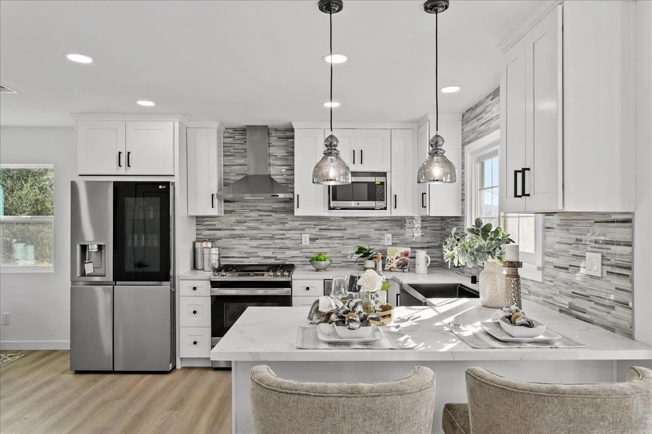506 Brotherton Road Escondido, CA 92025 - Photo 10 of 31 a kitchen with stainless steel appliances kitchen island granite countertop a stove a sink and a granite counter tops
