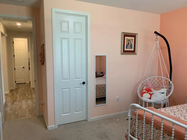 a bathroom with a granite countertop sink a toilet a mirror and shower