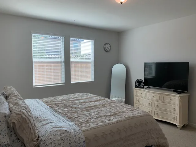 a bedroom with a bed and window