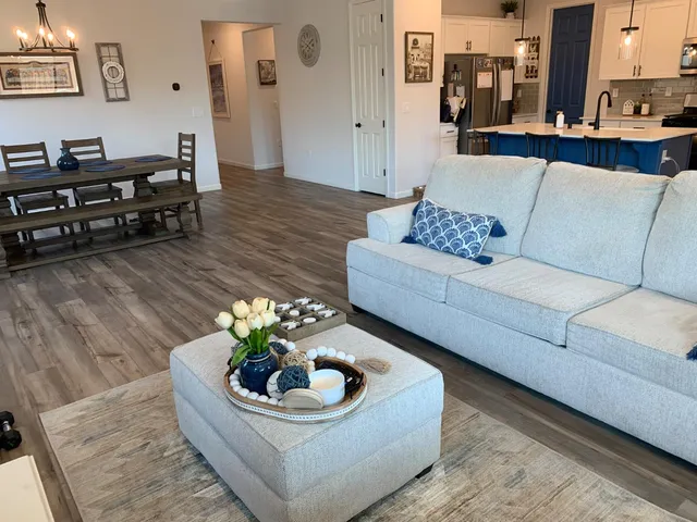 a view of a dining room with furniture wooden floor and a chandelier