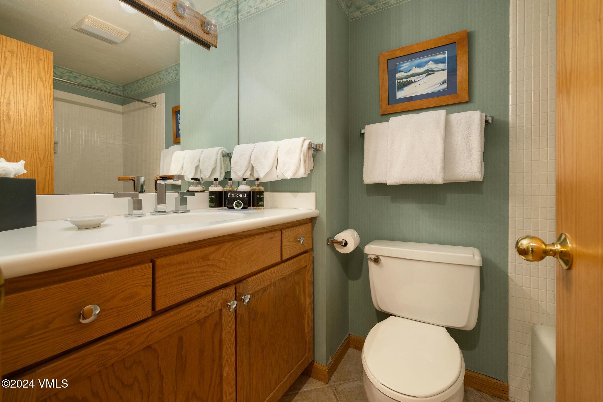 200 Vail Road, Unit 394 Vail, CO 81657 - Photo 11 of 16 a bathroom with a toilet sink and mirror