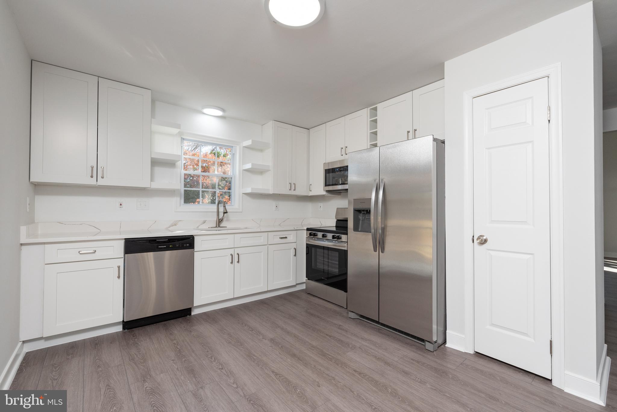 1709 Headwaters Road Midlothian, VA 23113 - Photo 18 of 42 a kitchen with a refrigerator sink and cabinets
