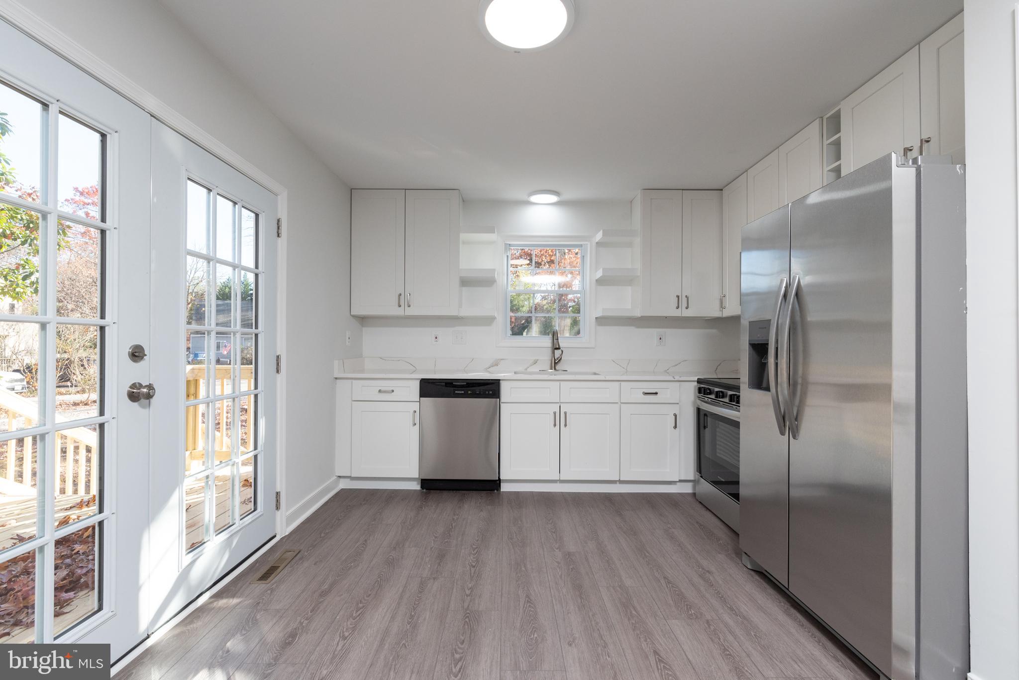 1709 Headwaters Road Midlothian, VA 23113 - Photo 20 of 42 a kitchen with a refrigerator a sink and cabinets