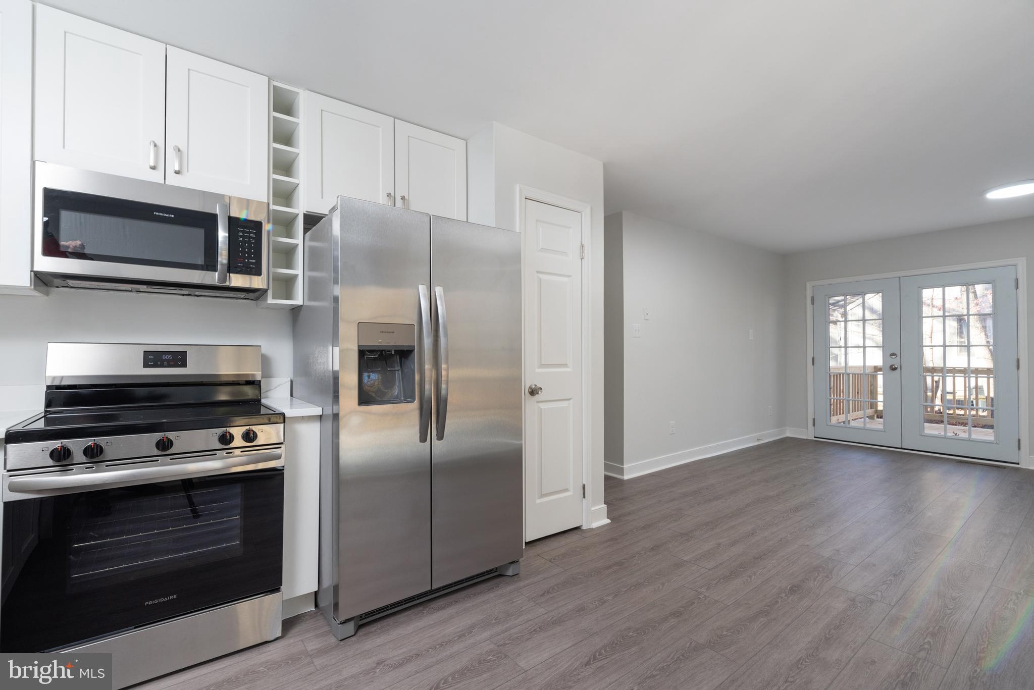 1709 Headwaters Road Midlothian, VA 23113 - Photo 21 of 42 a kitchen with stainless steel appliances a stove a microwave and a hard wood floors