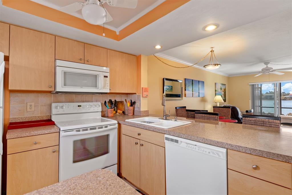 25275 Rampart Boulevard, Unit 202 Punta Gorda, FL 33983 - Photo 11 of 28 a kitchen with a stove a sink and a refrigerator