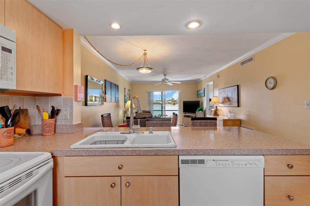 25275 Rampart Boulevard, Unit 202 Punta Gorda, FL 33983 - Photo 12 of 28 a kitchen with sink stove and cabinets