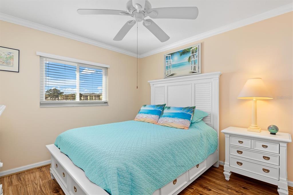 25275 Rampart Boulevard, Unit 202 Punta Gorda, FL 33983 - Photo 13 of 28 a bedroom with a bed and a dresser