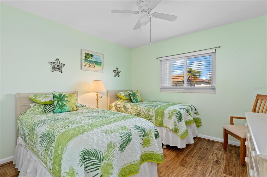 25275 Rampart Boulevard, Unit 202 Punta Gorda, FL 33983 - Photo 16 of 28 a bedroom with two beds and a wooden floor