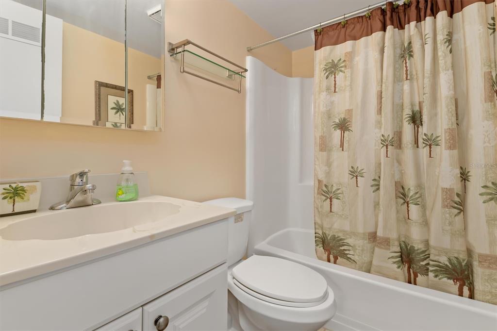 25275 Rampart Boulevard, Unit 202 Punta Gorda, FL 33983 - Photo 17 of 28 a bathroom with a sink a toilet and shower