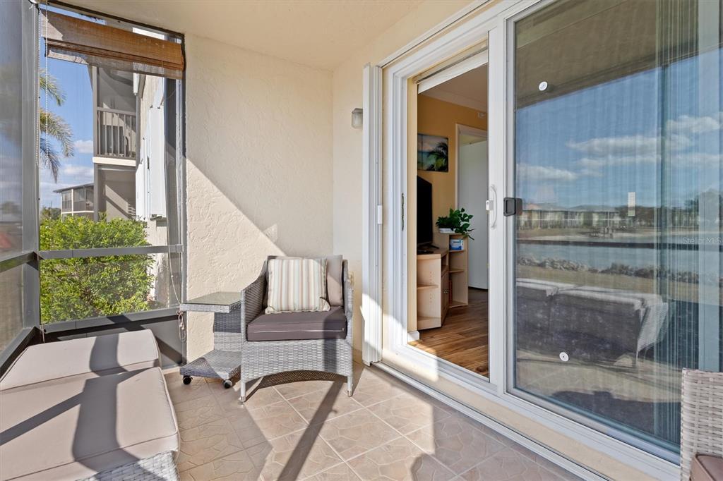 25275 Rampart Boulevard, Unit 202 Punta Gorda, FL 33983 - Photo 19 of 28 a living room with furniture and a floor to ceiling window