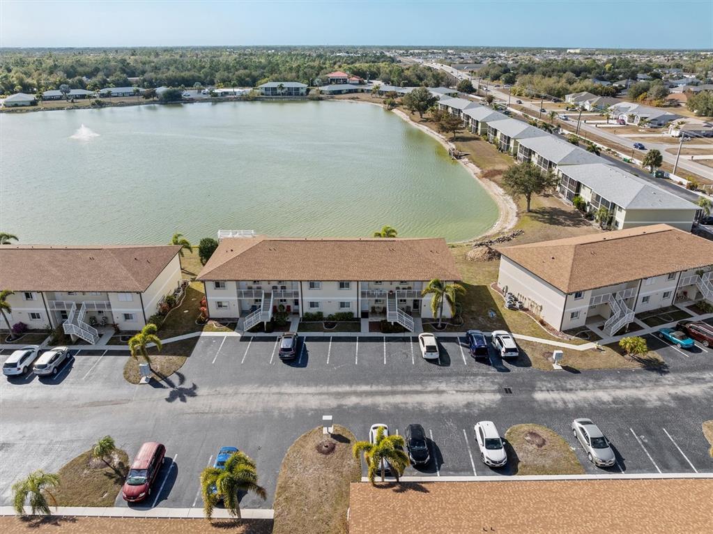 25275 Rampart Boulevard, Unit 202 Punta Gorda, FL 33983 - Photo 23 of 28 a view of a lake with sitting area