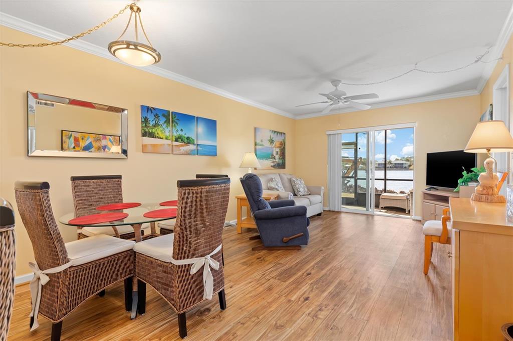 25275 Rampart Boulevard, Unit 202 Punta Gorda, FL 33983 - Photo 4 of 28 a living room with furniture and a flat screen tv