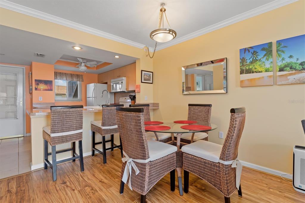 25275 Rampart Boulevard, Unit 202 Punta Gorda, FL 33983 - Photo 5 of 28 a dining room with furniture and wooden floor