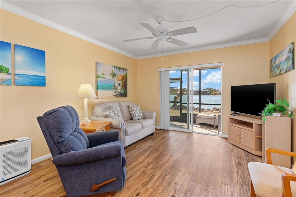 25275 Rampart Boulevard, Unit 202 Punta Gorda, FL 33983 - Photo 6 of 28 a living room with furniture and a flat screen tv