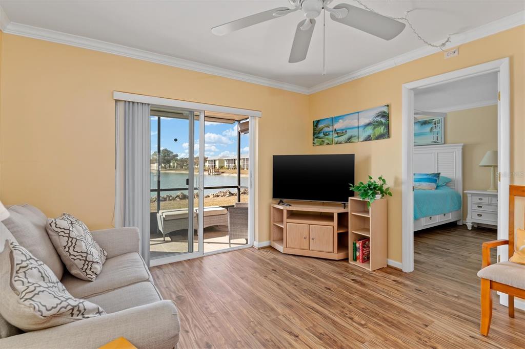 25275 Rampart Boulevard, Unit 202 Punta Gorda, FL 33983 - Photo 7 of 28 a living room with furniture and a flat screen tv
