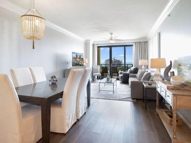 a living room with furniture a chandelier and a table